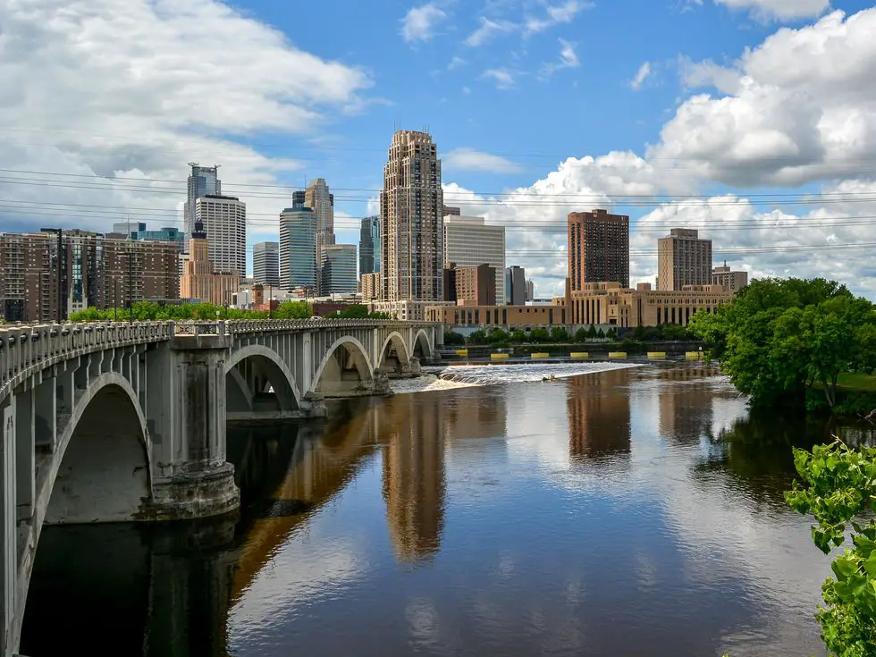Arch Bridge Over River By Buildings Against Sky Minneapolis Minnesota