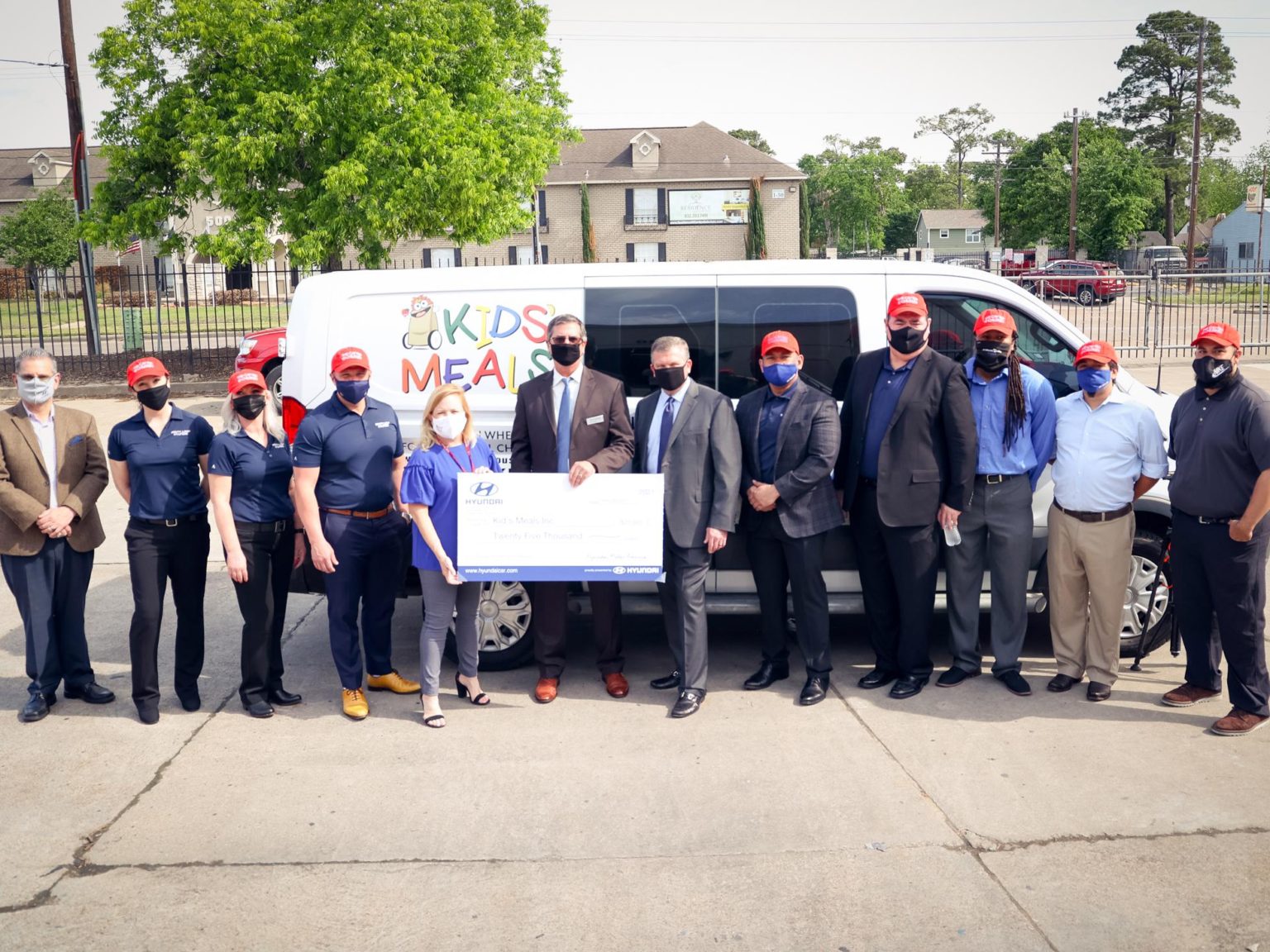 Hyundai employees present a check for $25,000 to Kids Meals Inc.