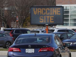 Signage greets people who arrive to line up for COVID-19 vaccinations at Nassau Community College on January 10, 2021 in Garden City, New York.