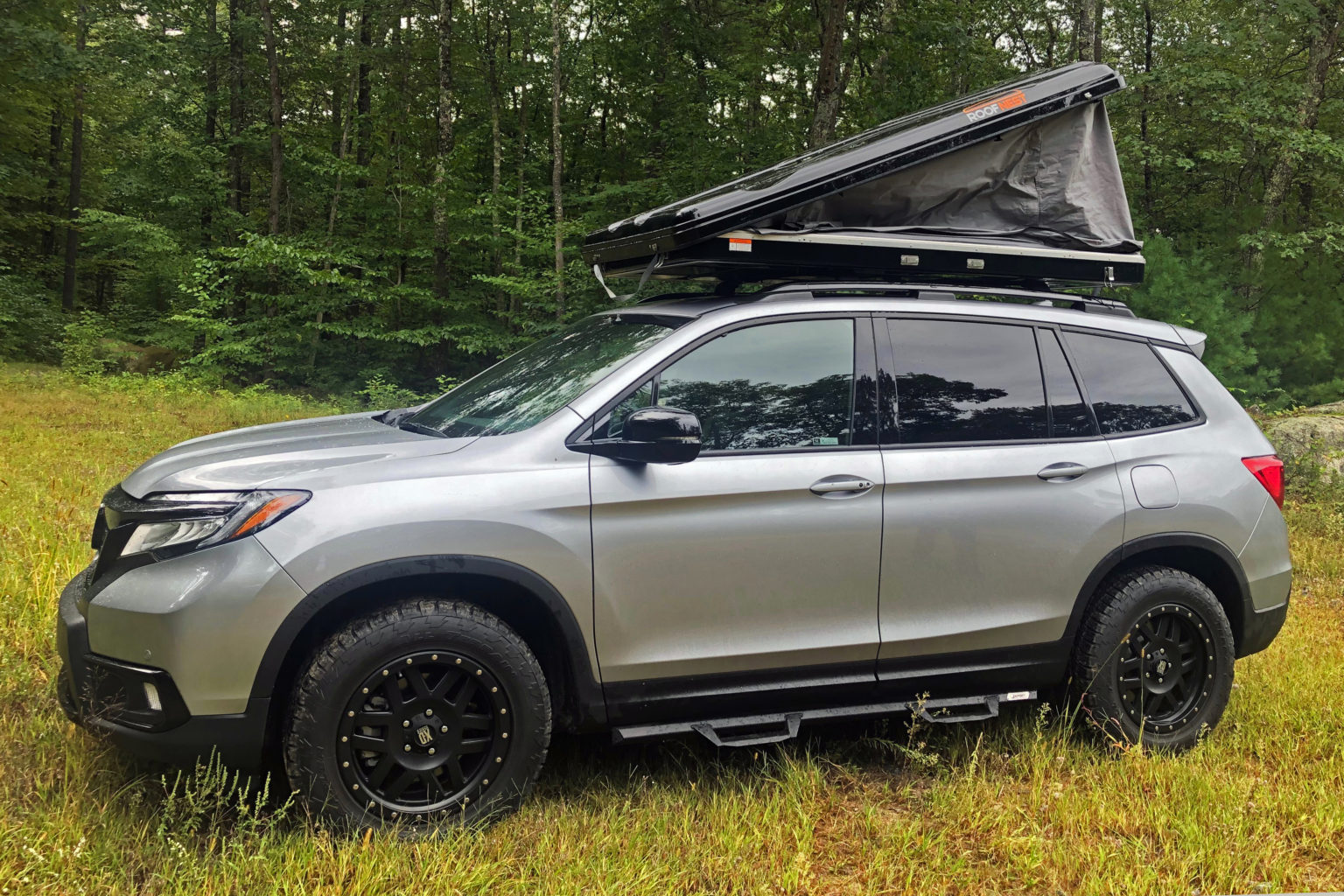 The Roofnest Sparrow rooftop tent fits snugly on the Honda Passport.
