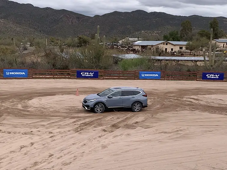 The Honda CR-V Hybrid comes standard with all-wheel drive. Here, the driver tests the system in a rodeo ring in Tucson, Arizona during the launch of the vehicle.