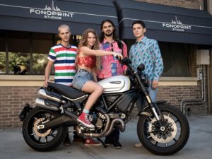 Eugenia Post Modern poses with a Ducati Scrambler in a publicity photo for the musical series.