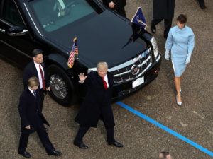 U.S. President Donald Trump waves to supporters as he walks the parade route with first lady Melania Trump and son Barron Trump during the Inaugural Parade on January 20, 2017 in Washington, DC.